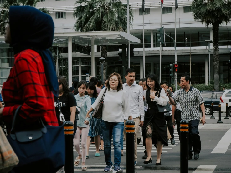 a group of people walking across a street, pexels contest winner, jakarta, avatar image, asian female, background image