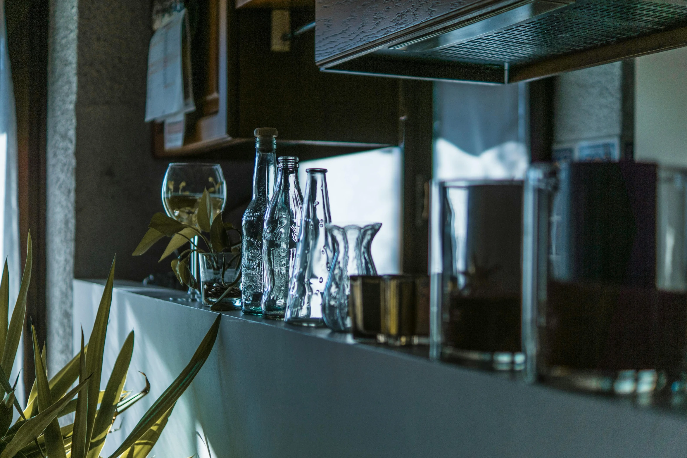 a bunch of glasses sitting on top of a counter, inspired by Elsa Bleda, unsplash, renaissance, detailed ambient lighting, kitchen counter, iconostasis in the bar, silver small small small glasses