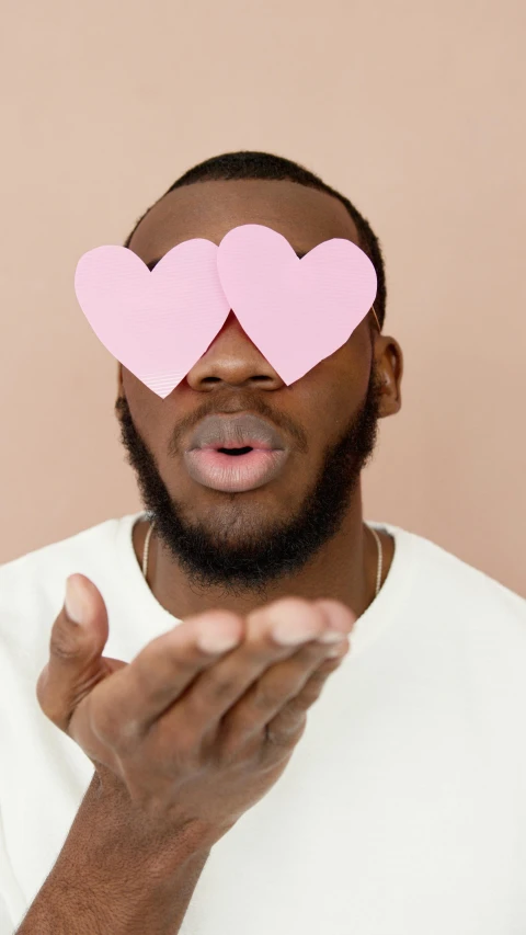 a man with two pink hearts on his face, trending on pexels, essence, thicc, romantic lead, nerds