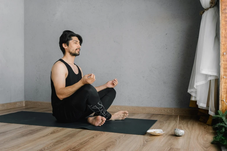 a man sitting on a yoga mat in a room, pexels contest winner, smoking with squat down pose, japanese collection product, thumbnail, anjali mudra