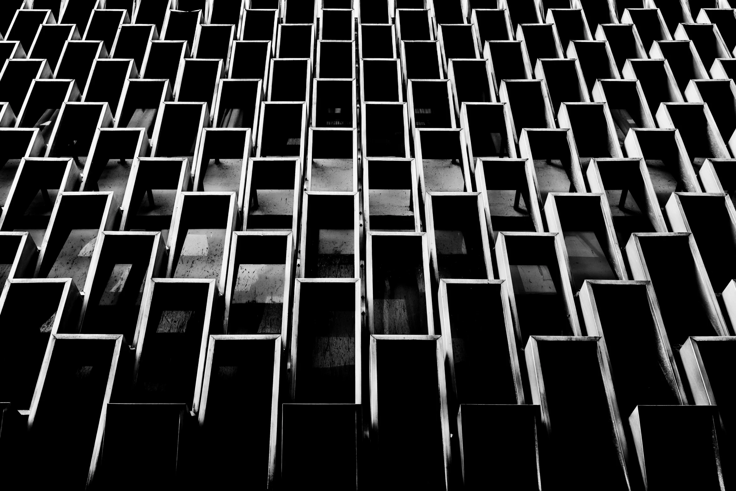 a black and white photo of a building, inspired by Donald Judd, unsplash, brutalism, ffffound, cubicles, tokio, ossuary