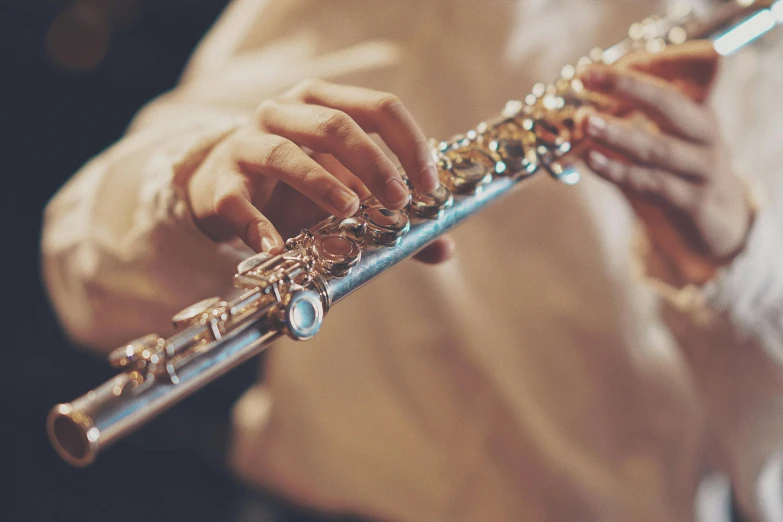 a close up of a person playing a flute, pexels contest winner, arabesque, shiny silver, many small details, thumbnail, band playing