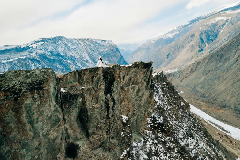 a group of people standing on top of a mountain, pexels contest winner, sharp cliffs, ash thorp khyzyl saleem, inuk, girl walking on cliff