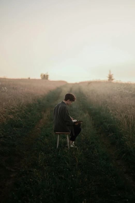 a person sitting on a chair in a field, pexels contest winner, paul barson, sitting at a desk, music, walking down