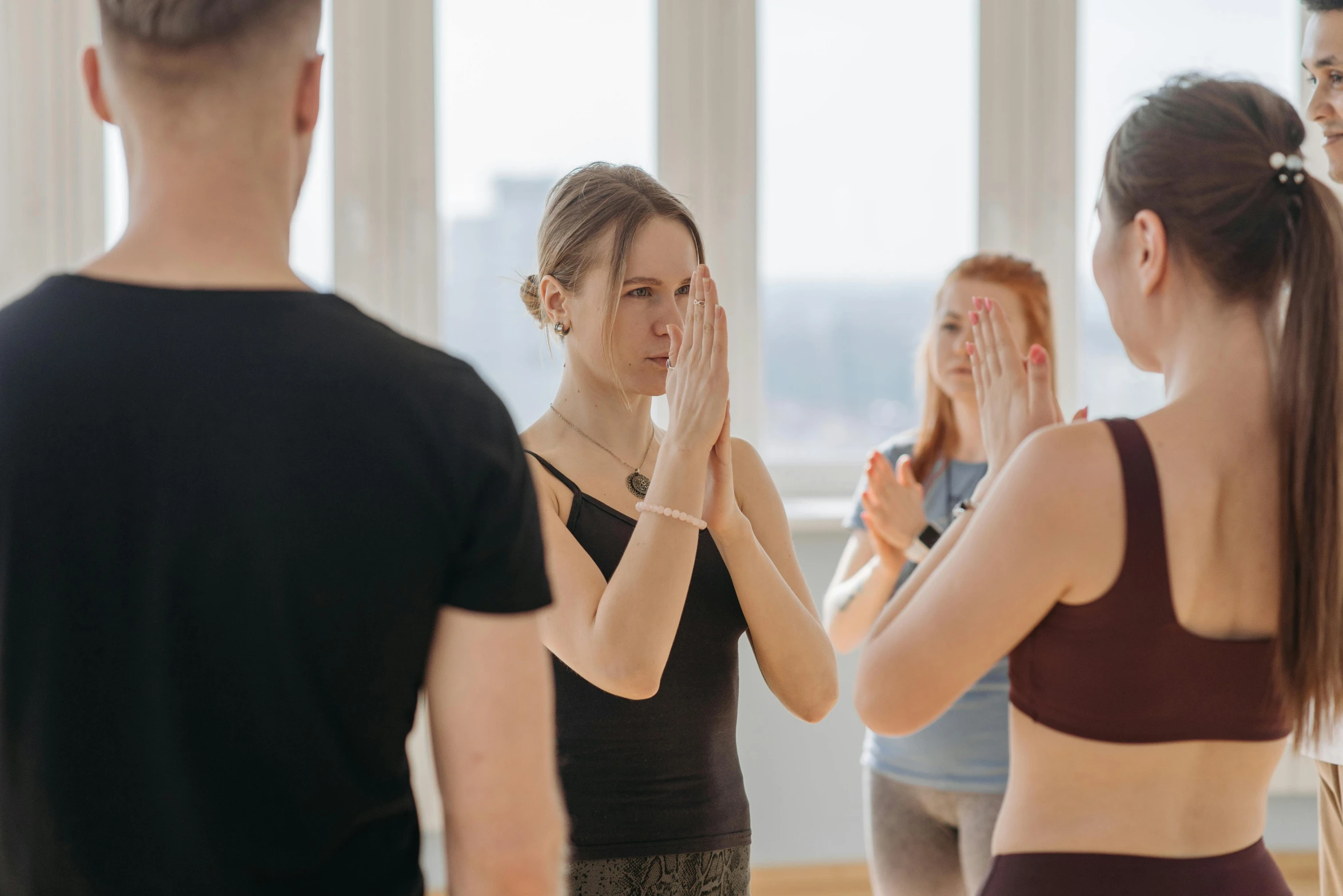 a group of people standing around each other in a room, by Nina Hamnett, trending on pexels, renaissance, yoga pose, background image, low quality photo, hand over mouth