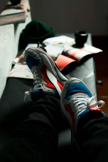 a person sitting on a couch with their feet up, a picture, pexels contest winner, renaissance, sneaker photo, blue and red two - tone, sports car in the room, taken in the late 2010s