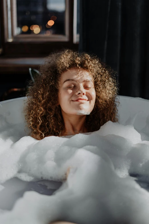 a woman taking a bubble bath in a bathtub, trending on pexels, renaissance, long brown puffy curly hair, covered in clouds, smug smile, gif