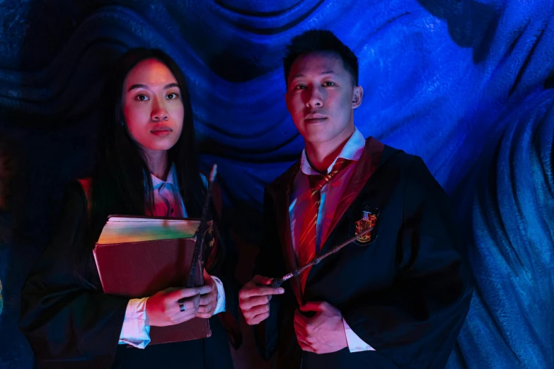 a couple of people standing next to each other, holding a wand, darren quach, creepy themed, colourful dramatic lighting