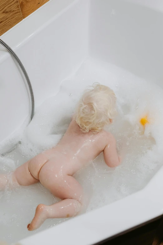 a baby is taking a bath in a bathtub, trending on reddit, toy commercial photo, albino skin, cupid, bum