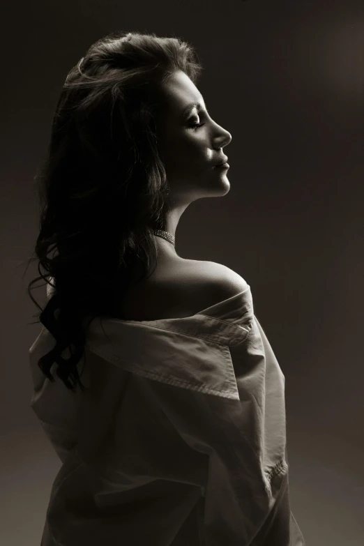 a black and white photo of a woman in a dress, inspired by Yousuf Karsh, pixabay contest winner, clothed in white shirt, back light, studio medium format photograph, bare shoulders