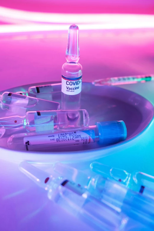 a group of vials sitting on top of a table, a picture, purple and pink and blue neons, syringe, thumbnail, feature