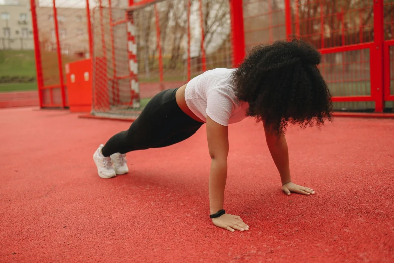 a woman doing push ups on a basketball court, pexels contest winner, white and red body armor, people falling off a playground, profile image, physical : tinyest midriff ever