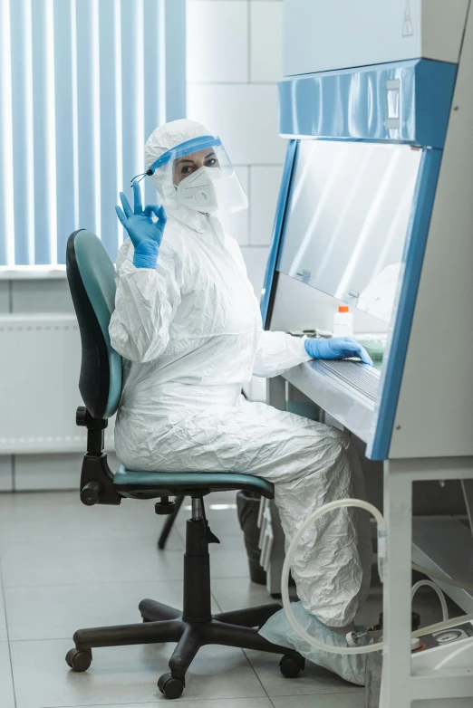 a man in a protective suit working on a computer, a portrait, shutterstock, door to lab, plastic and fabric, woman, 15081959 21121991 01012000 4k