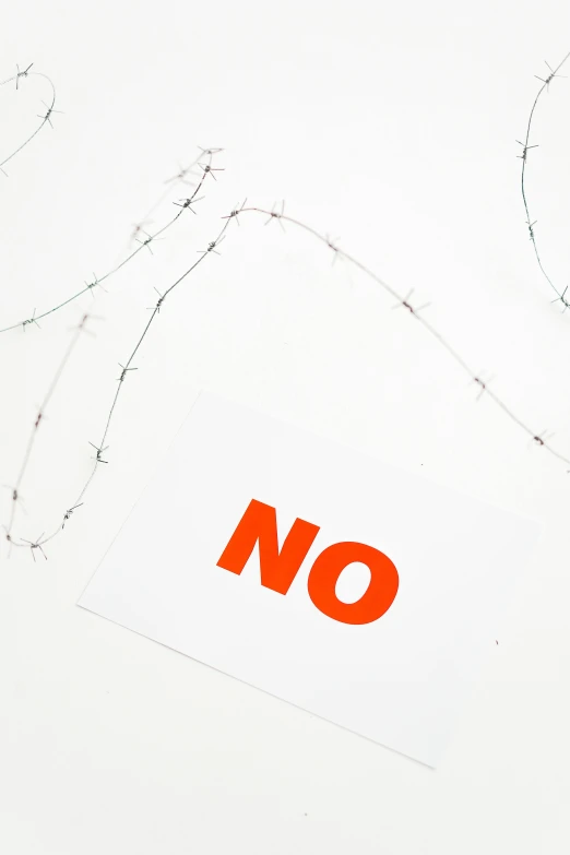 a pair of scissors sitting on top of a piece of paper, neoism, showstudio, orange safety labels, point of no return, barbed wire