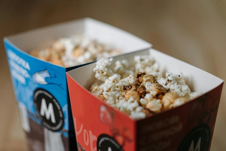 two boxes of popcorn sitting on a table, by Emma Andijewska, trending on pexels, mingei, close-up product photo, avatar image, mekka, mix
