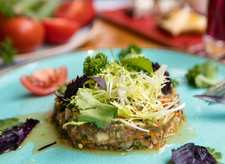 a close up of a plate of food on a table, by Julia Pishtar, alien colorful greenery, tamborine, daily specials, aspic