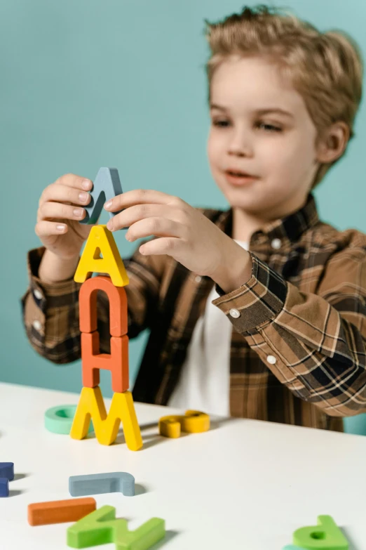 a little boy that is sitting at a table, pexels contest winner, letterism, building blocks, holding a rocket, mega structure, asset on grey background