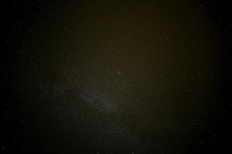 a dark sky filled with lots of stars, a picture, pexels, brown, detailed medium format photo, digital image, low quality footage