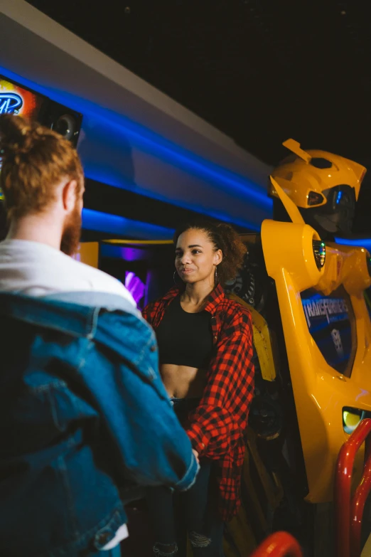 a group of people playing a video game, bumblebee, in a nightclub, taken with sony alpha 9, doja cat