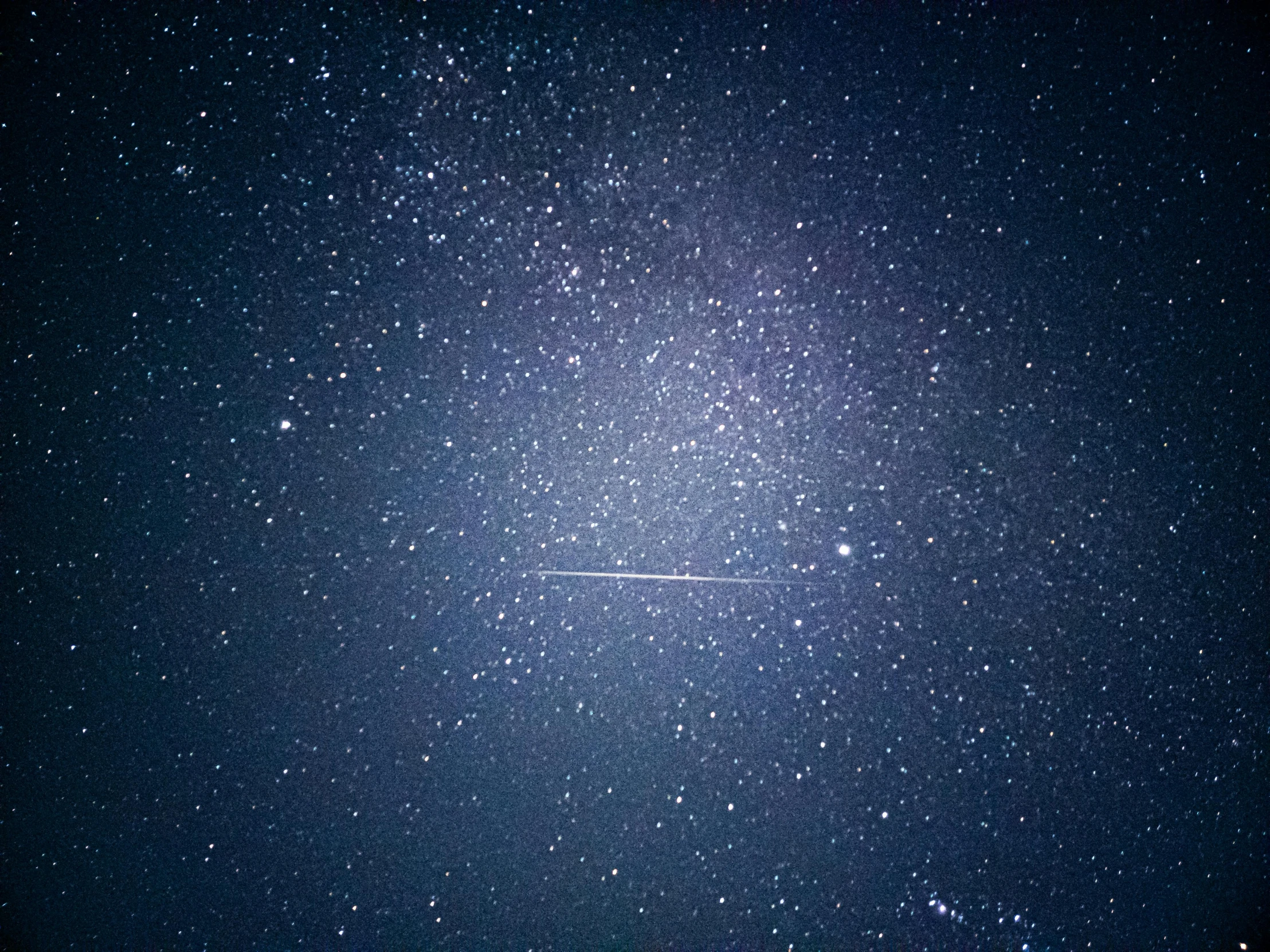 a plane is flying through the night sky, a microscopic photo, by Niko Henrichon, pexels, space art, shooting star, an ultrafine detailed photo, blue fireball, tiny stars