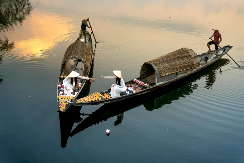 a couple of boats that are sitting in the water, inspired by Steve McCurry, pexels contest winner, conceptual art, ao dai, thumbnail, cornucopia, late afternoon