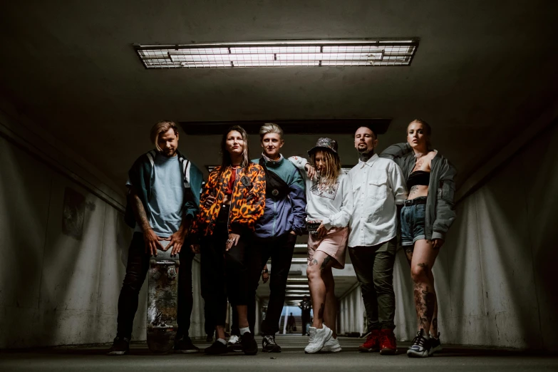 a group of people standing next to each other, a portrait, pexels contest winner, antipodeans, urban clothing, high lights, press shot, indoor picture