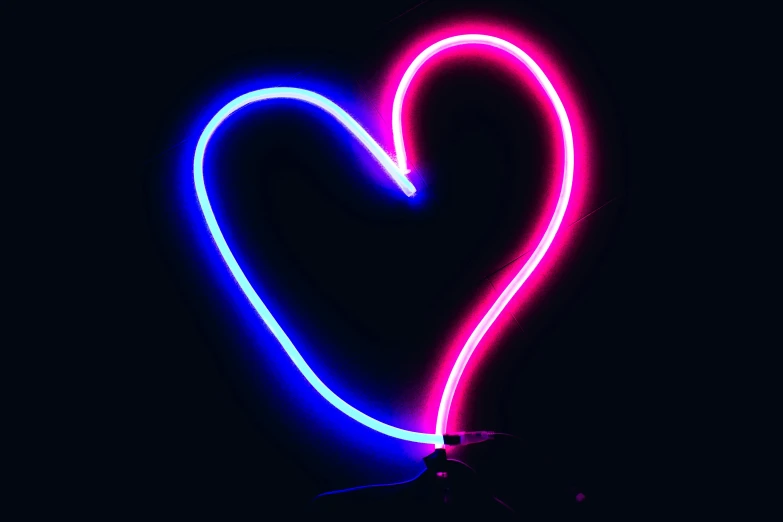 a person holding a neon light up in the shape of a heart, an album cover, inspired by Tracey Emin, pexels, blue black pink, ((neon colors)), neon sign, single light