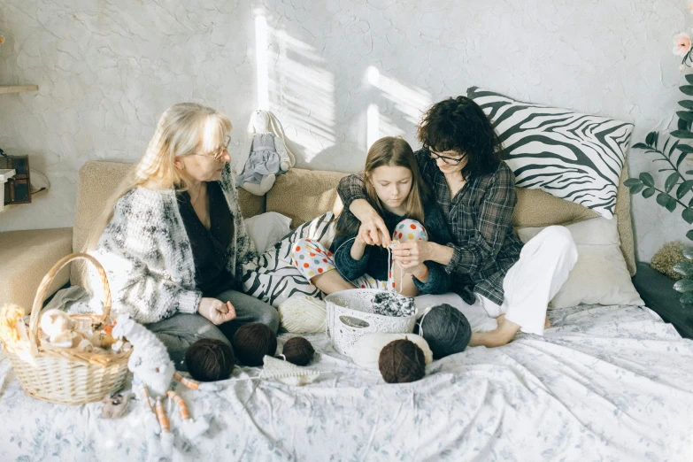 a group of women sitting on top of a bed, by Elaine Hamilton, pexels contest winner, families playing, crafts, ( ultra realistic, three