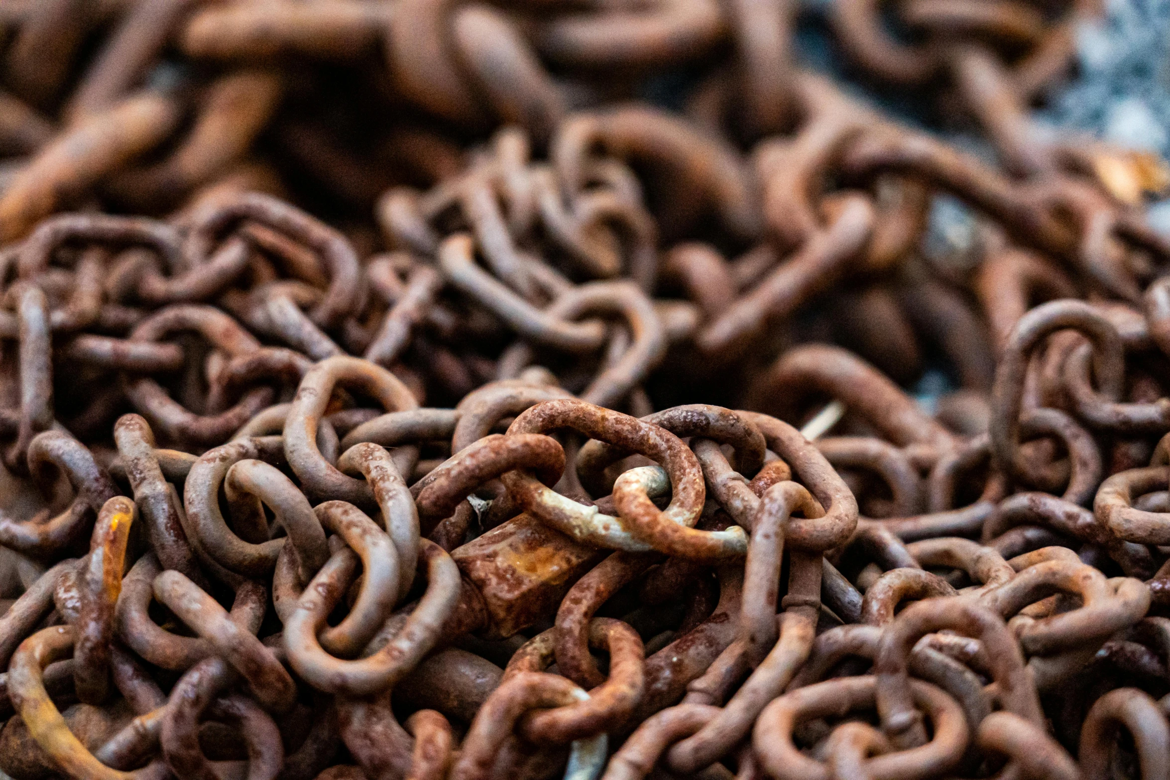 a pile of rusty chains sitting on top of a table, trending on pexels, 🦩🪐🐞👩🏻🦳, fish hooks, chocolate, red iron oxide