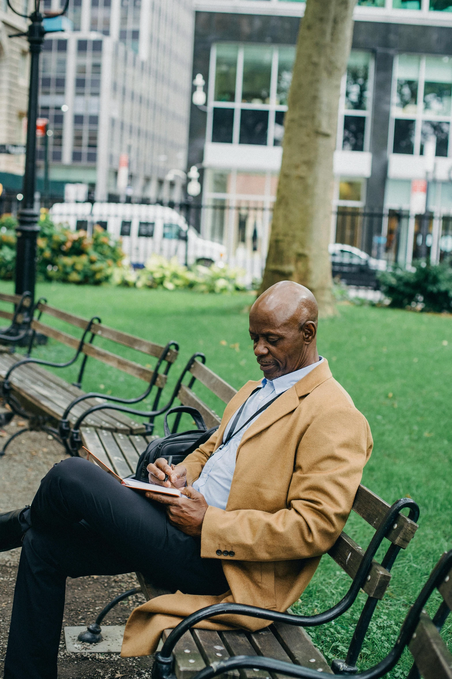 a man sitting on a bench reading a book, lance reddick, in new york city, integrating with technology, handwritten