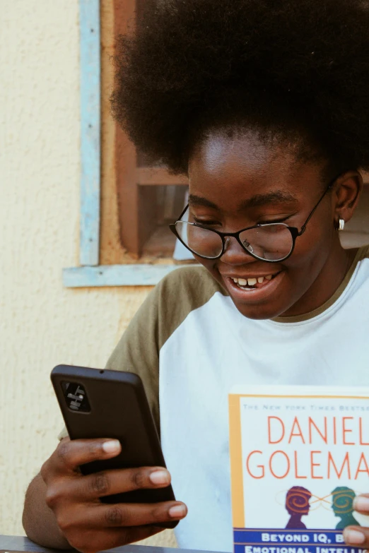 a woman sitting at a table using a cell phone, by Daniel Seghers, pexels contest winner, happening, black teenage boy, wearing reading glasses, wholesome, everything fits on the screen