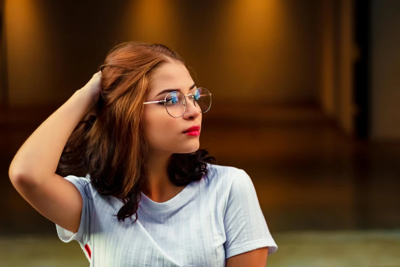 a woman with glasses sitting at a table, inspired by Elsa Bleda, trending on pexels, renaissance, avatar image, square rimmed glasses, attractive brown hair woman, 18 years old