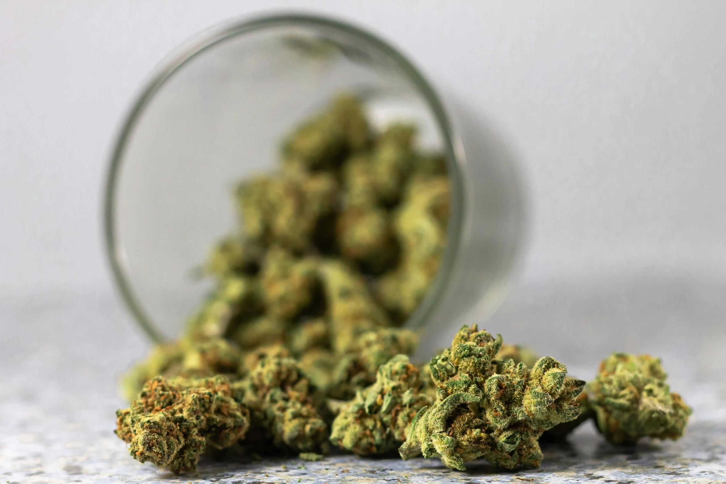 a jar of marijuana sitting on top of a table, pexels, high delicate details, bending down slightly, weed background, buds