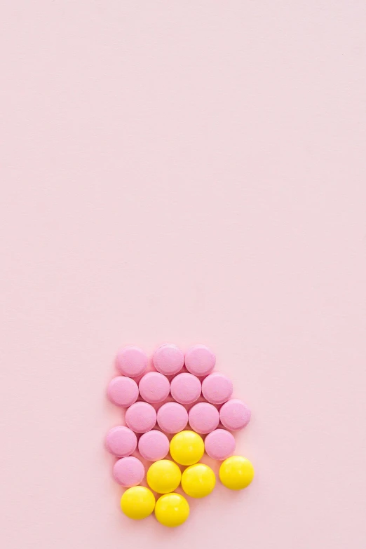 pink and yellow pills on a pink background, by Sam Havadtoy, postminimalism, chocolate, ( conceptual art ), jen atkin, on grey background