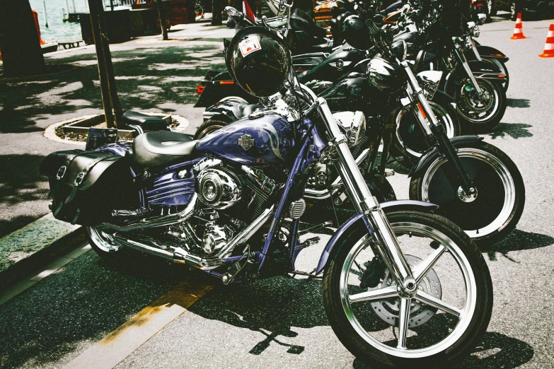 a row of motorcycles parked on the side of the road, a colorized photo, pexels contest winner, purple and blue leather, new york city, 🚿🗝📝