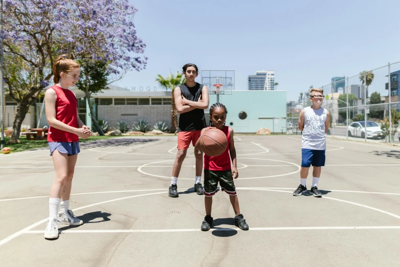 a group of people playing a game of basketball, by Gavin Hamilton, hyperrealism, hollywood promotional image, lachlan bailey, low quality photo, boys and girls