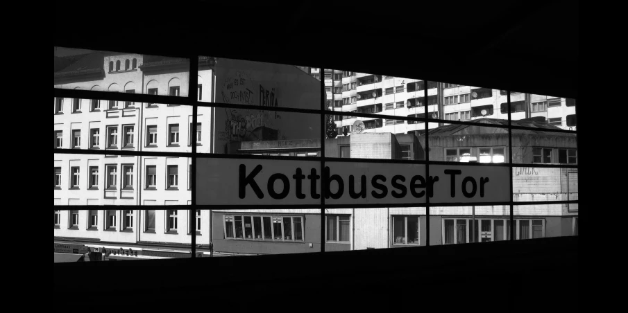 a black and white photo of a street sign, by Karl Buesgen, next to a big window, bussiere rutkowski andreas rocha, bus station, touring