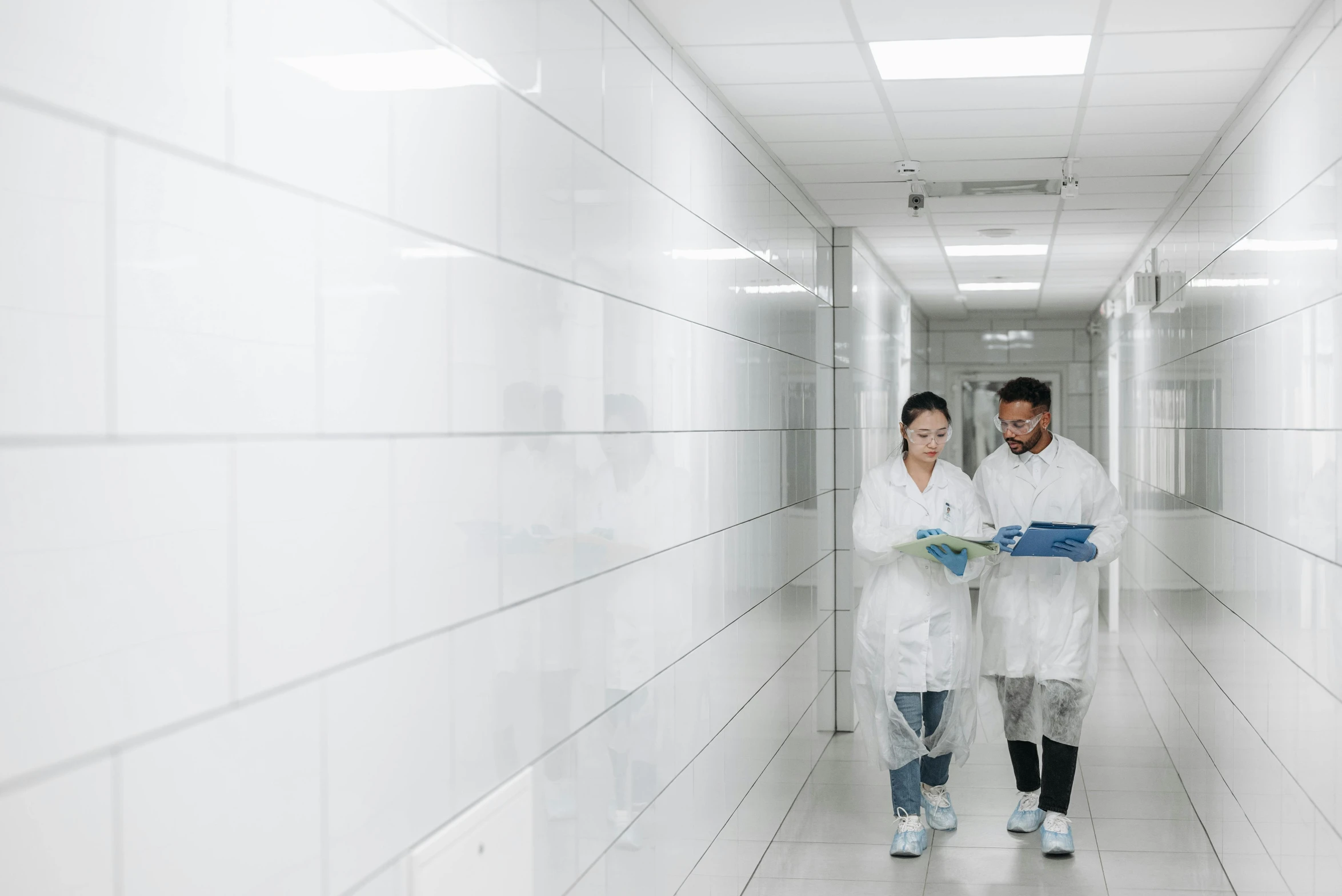 a couple of people that are standing in a hallway, medical lab, studying in a brightly lit room, profile image, industries