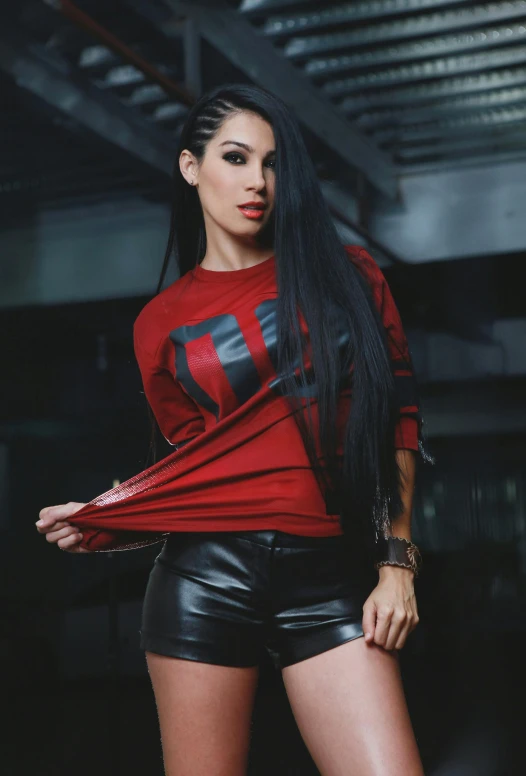 a woman in a red shirt and black leather shorts, by Robbie Trevino, featured on reddit, cybertech wear, wearing sweatshirt, promo image, female with long black hair