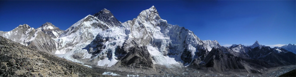 a group of snow covered mountains against a blue sky, really large bosum, avatar image, from wikipedia, fan favorite