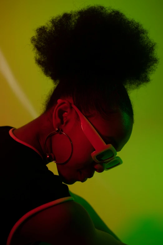 a close up of a person with a cell phone, inspired by Carrie Mae Weems, afrofuturism, headphones dj rave, with a ponytail, shot with sony alpha, shades green and red