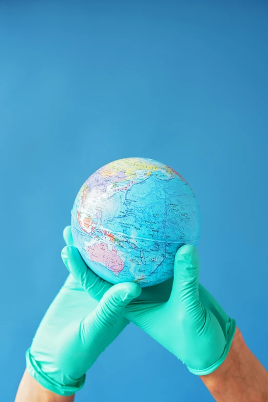 a person holding a globe in their hands, sterile colours, surgical supplies, multiple stories, cyan
