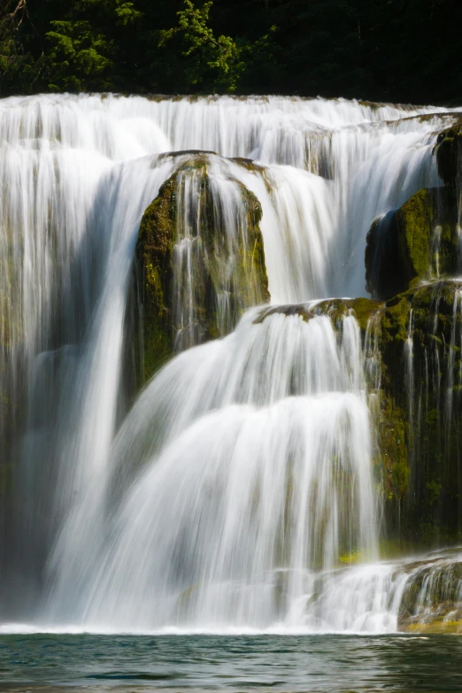 a large waterfall in the middle of a forest, close - up photograph, idaho, trending photo, full frame image