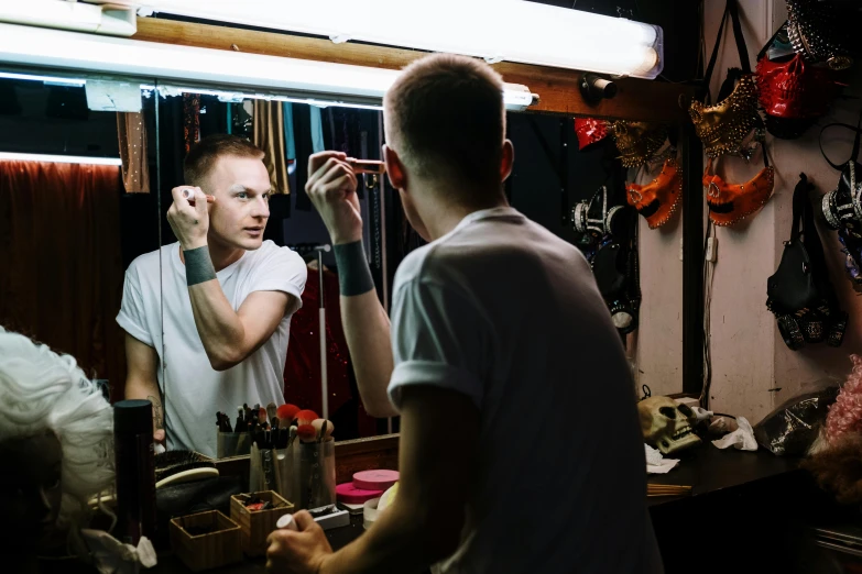 a man that is standing in front of a mirror, by Julia Pishtar, pexels, theater dressing room, putting makeup on, vitalik buterin, avatar image