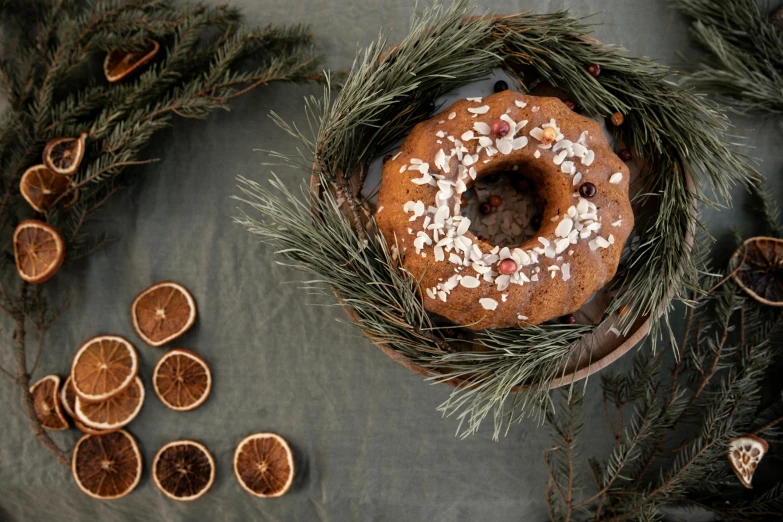 a cake that is sitting on top of a table, by Emma Andijewska, hurufiyya, seasonal, full frame image, blender donut, evergreen branches