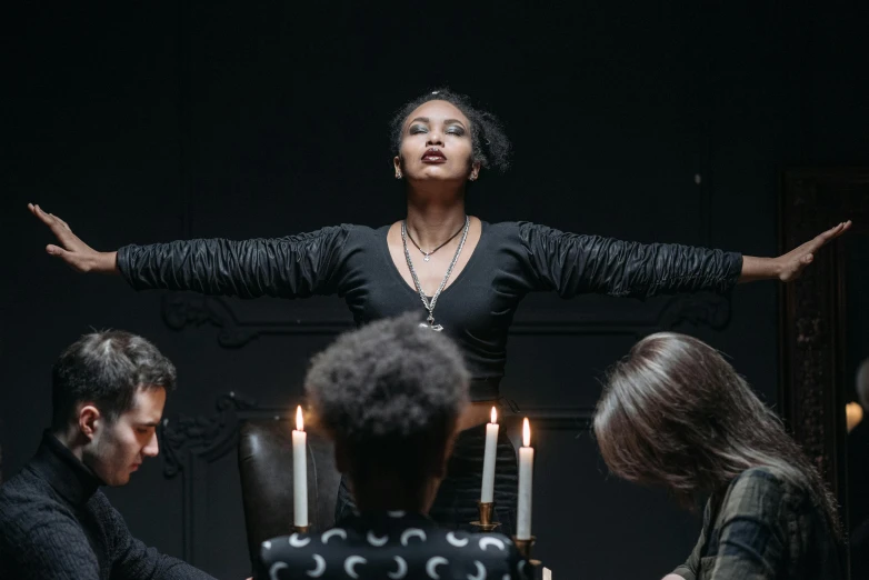 a group of people sitting around a table with candles, pexels contest winner, renaissance, an ahoge stands up on her head, imaan hammam, pulling the move'the banshee ', classical witch