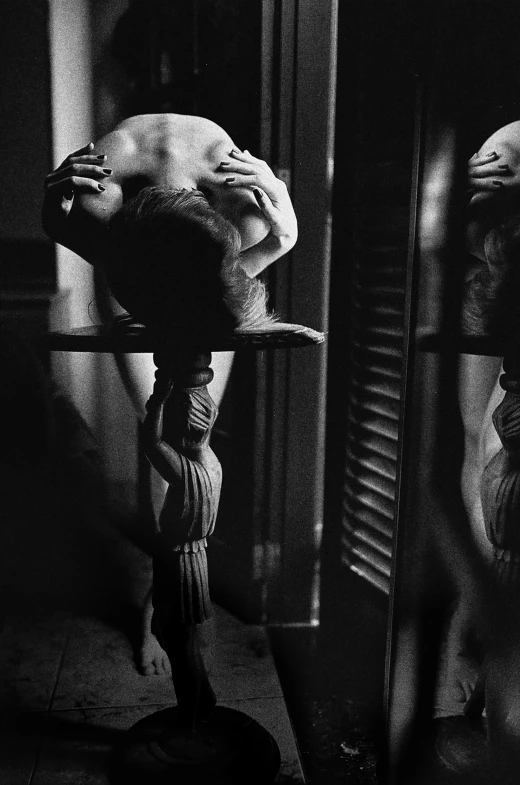 a man doing a handstand in front of a mirror, inspired by Peter Basch, sensual woman, 1996)