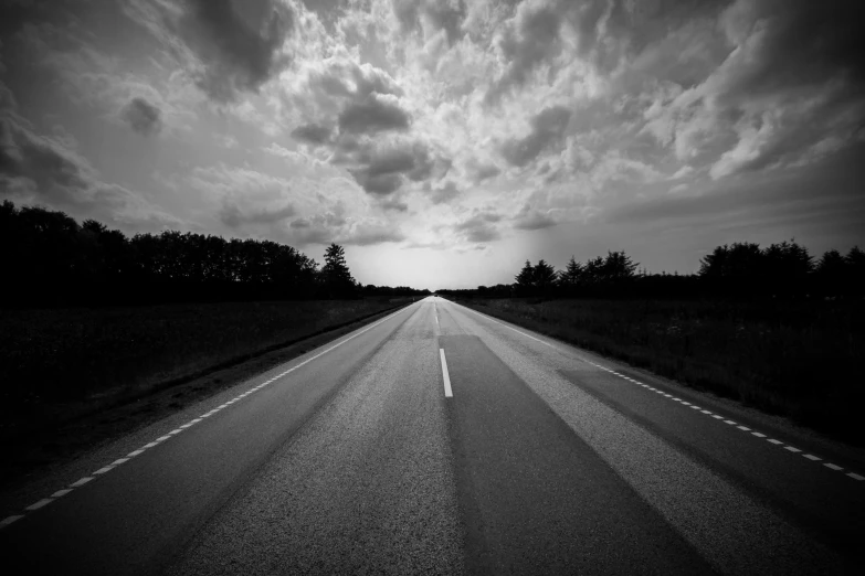 a black and white photo of an empty road, dramatic sky, uploaded, item, full width