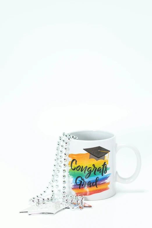 a coffee mug with a graduation cap on it, a picture, rainbow stripe backdrop, hi-res, - 9