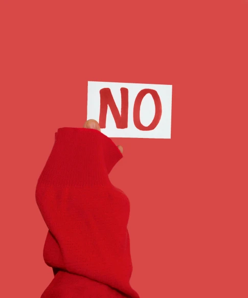 a person holding a sign that says no, an album cover, trending on unsplash, antipodeans, red monochrome, without text, gay rights, red scarf
